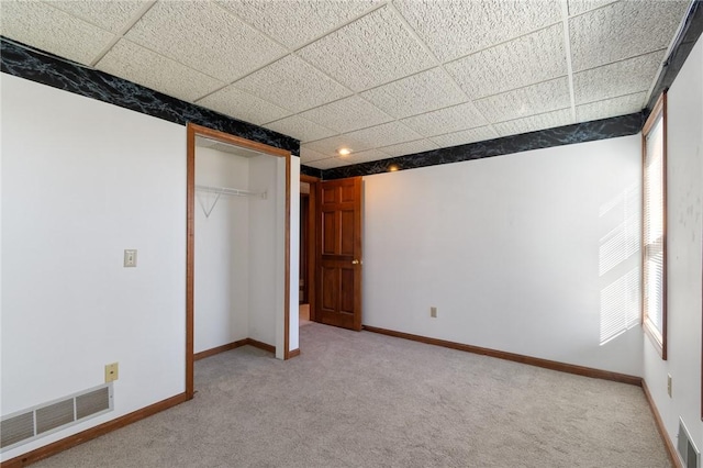 unfurnished bedroom with visible vents, baseboards, and carpet