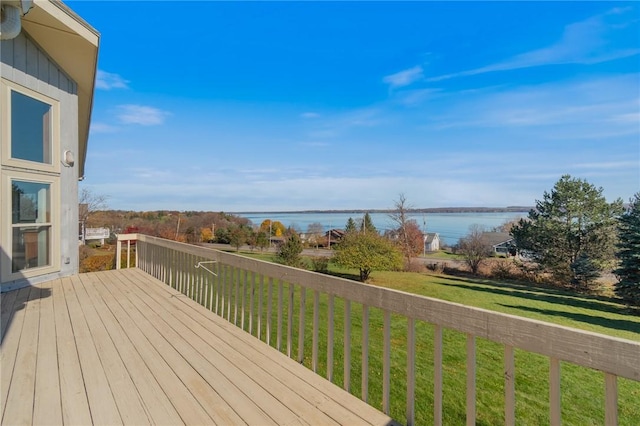 wooden terrace featuring a yard and a water view