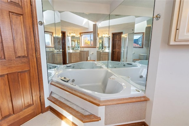 full bath featuring a shower stall, toilet, vanity, and a whirlpool tub