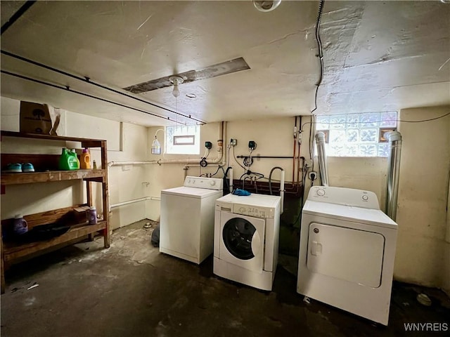 washroom with independent washer and dryer and laundry area