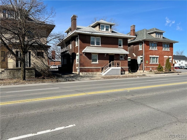 traditional style home with brick siding and a chimney