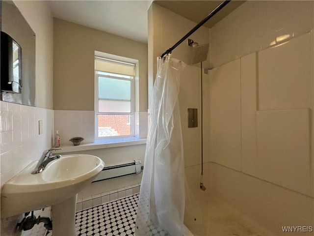 bathroom featuring a shower with curtain, tile walls, wainscoting, tile patterned flooring, and a baseboard radiator