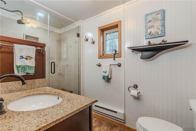 bathroom with vanity, a shower stall, crown molding, toilet, and baseboard heating