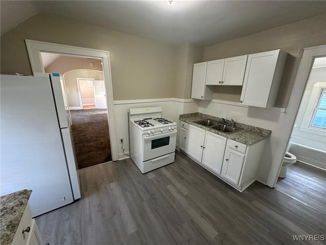 kitchen featuring a sink, white appliances, dark wood finished floors, and white cabinetry