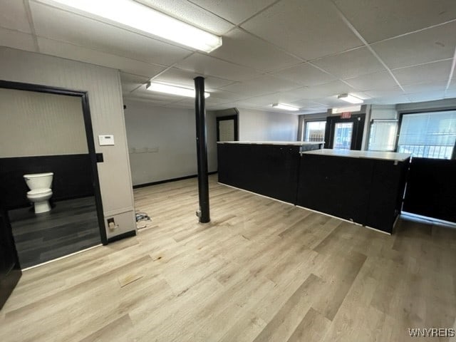 below grade area featuring a drop ceiling and light wood-style floors