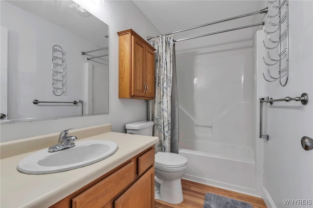 full bath with vanity, shower / tub combo, toilet, and wood finished floors