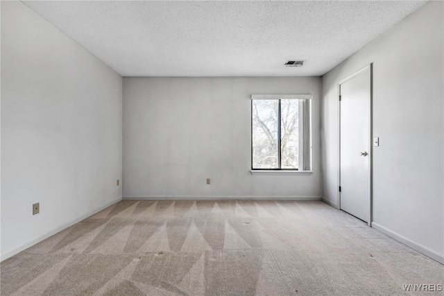 unfurnished bedroom featuring visible vents, a textured ceiling, baseboards, and carpet floors