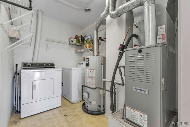 laundry area featuring gas water heater, washing machine and clothes dryer, light floors, and laundry area