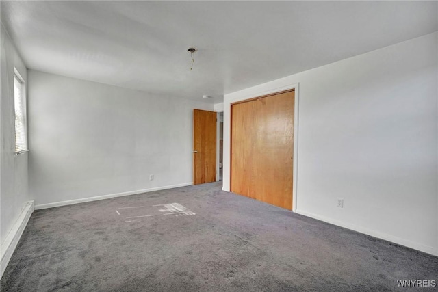 carpeted spare room featuring baseboards