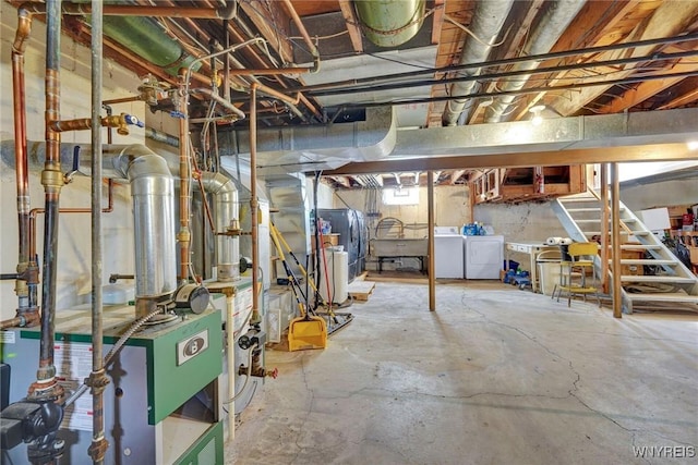 unfinished basement featuring washing machine and dryer and a heating unit