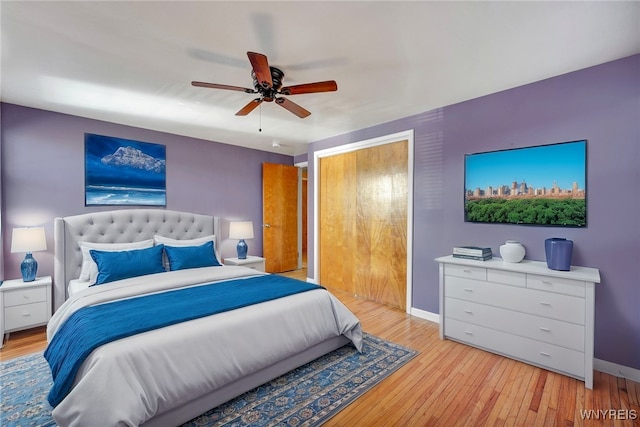 bedroom featuring light wood finished floors, ceiling fan, baseboards, and a closet