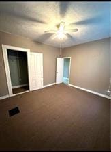 unfurnished bedroom with ceiling fan, carpet, and baseboards