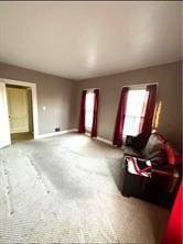 carpeted living room featuring baseboards