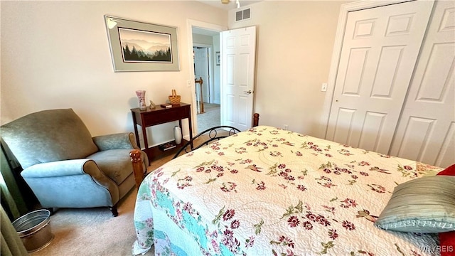 bedroom with visible vents, carpet floors, and a closet