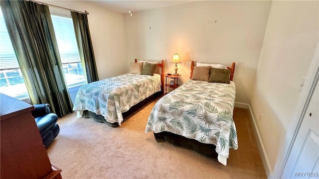 bedroom with baseboards and carpet