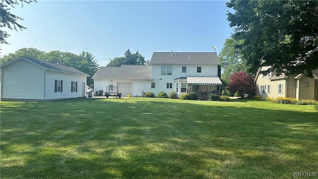 rear view of property with a yard