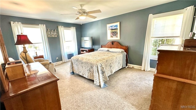 bedroom with carpet flooring, baseboards, and ceiling fan