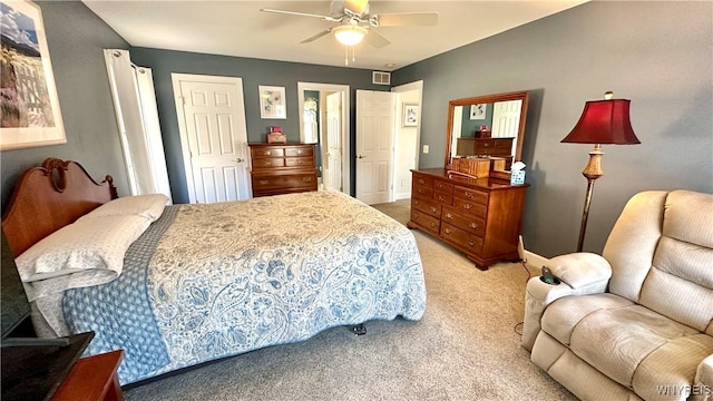 bedroom featuring visible vents, light carpet, a closet, baseboards, and ceiling fan