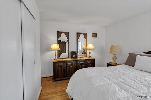 bedroom with baseboards and light wood-style floors