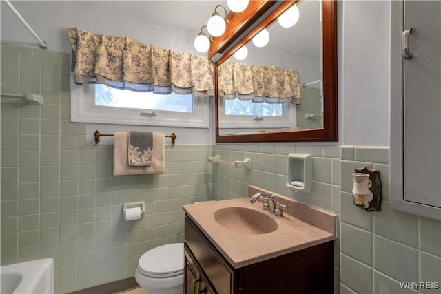 full bathroom featuring a shower, toilet, tile walls, and vanity