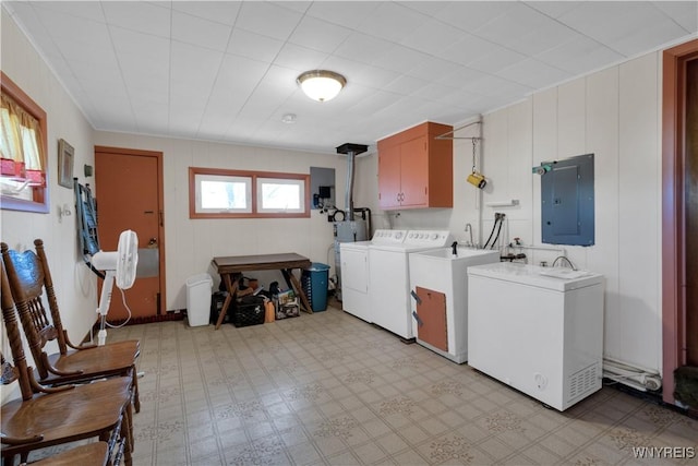 laundry area featuring electric panel, cabinet space, light floors, and independent washer and dryer