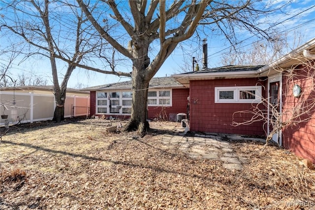 back of house featuring fence