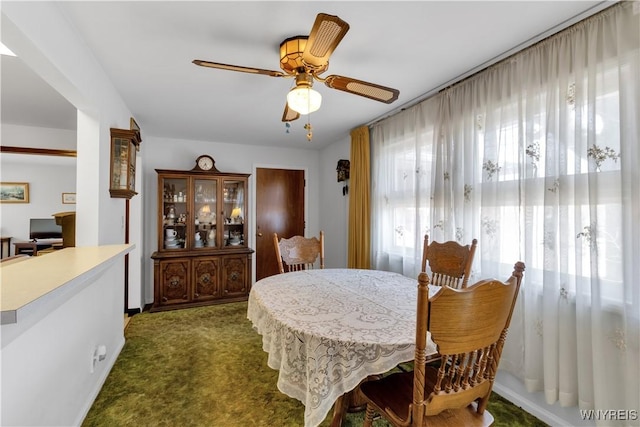 dining room with a ceiling fan and carpet floors