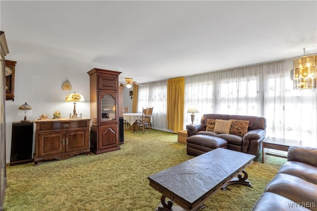 living room featuring light carpet and ceiling fan with notable chandelier