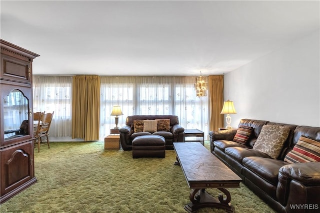 carpeted living area featuring a chandelier