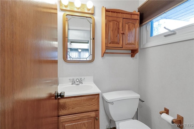 half bathroom with toilet and vanity