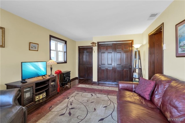 living area featuring wood finished floors and visible vents