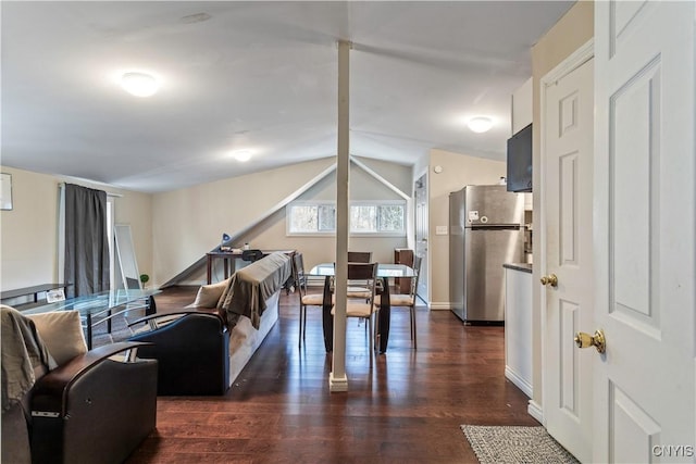 living room featuring dark wood finished floors, vaulted ceiling, and baseboards