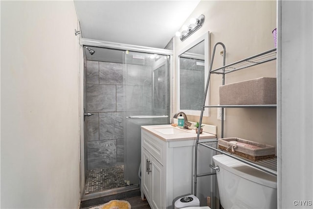 full bathroom with a stall shower, toilet, and vanity