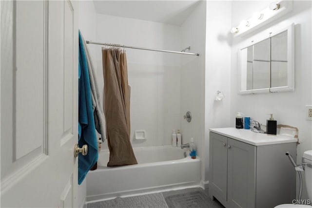 bathroom with shower / bath combo with shower curtain, toilet, and vanity