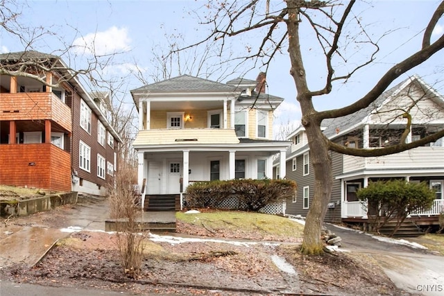 view of front of property featuring a balcony and a porch