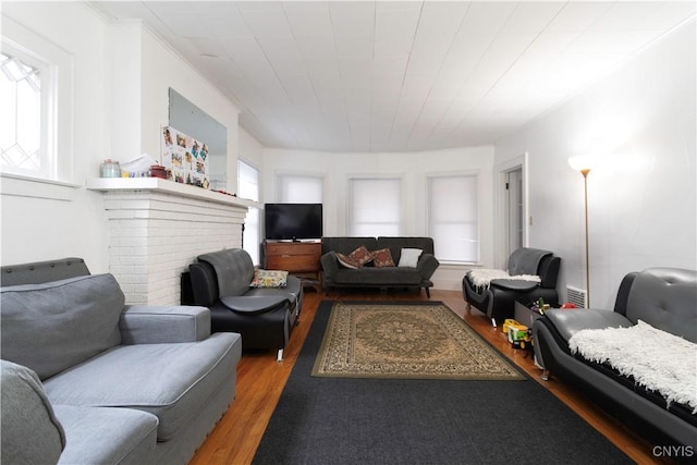 living area featuring a fireplace and light wood-type flooring