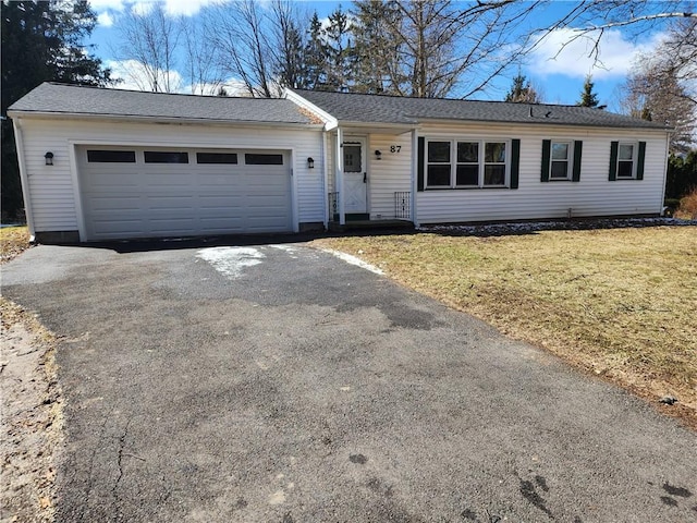 ranch-style home with a front yard, a garage, and aphalt driveway