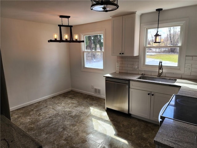 kitchen with baseboards, visible vents, a sink, dishwasher, and tasteful backsplash