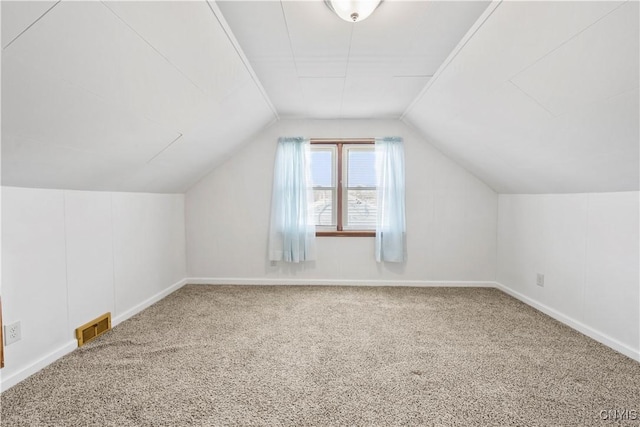 bonus room featuring visible vents, lofted ceiling, baseboards, and carpet flooring