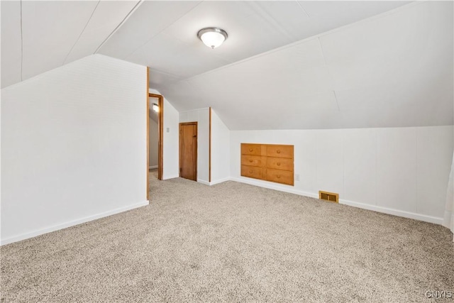 bonus room with visible vents, carpet floors, baseboards, and vaulted ceiling