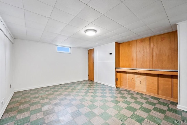 below grade area with tile patterned floors and baseboards