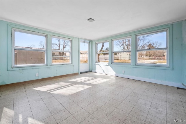 unfurnished sunroom featuring a wealth of natural light