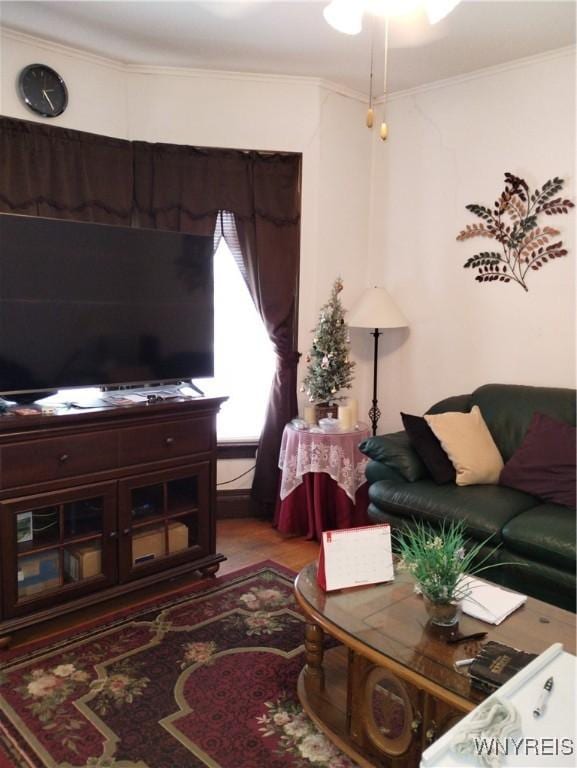 living room with crown molding and wood finished floors