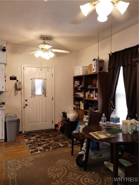 dining area featuring a ceiling fan and wood finished floors