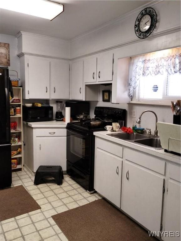 kitchen with white cabinetry, light countertops, a sink, and black appliances