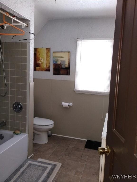 full bath with toilet, shower / bathing tub combination, and lofted ceiling