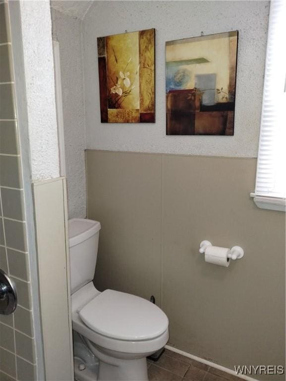 bathroom featuring toilet and tile patterned floors
