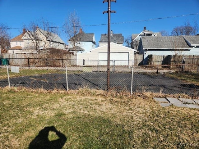 view of yard featuring a garage and fence