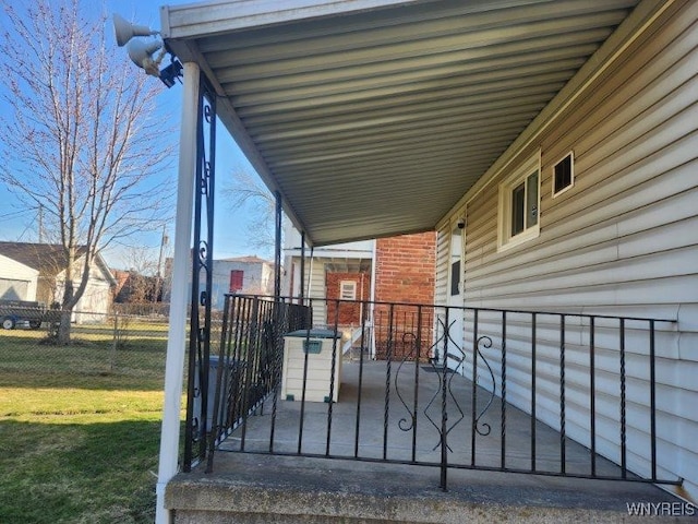 wooden deck featuring fence and a lawn