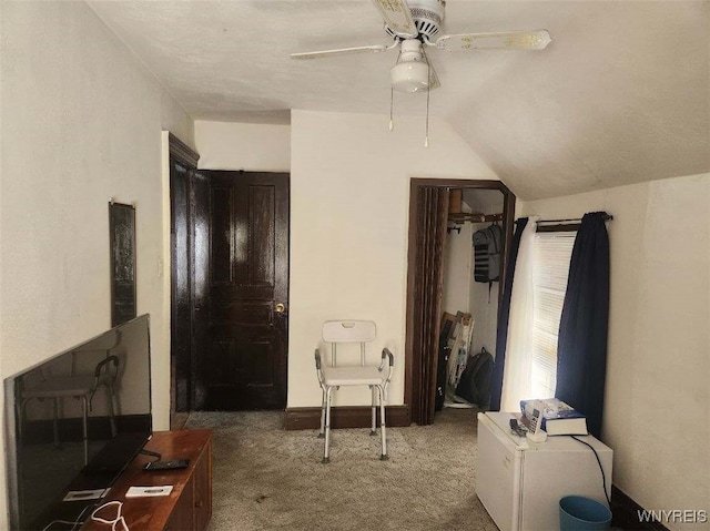 bedroom with baseboards, vaulted ceiling, carpet floors, and a ceiling fan